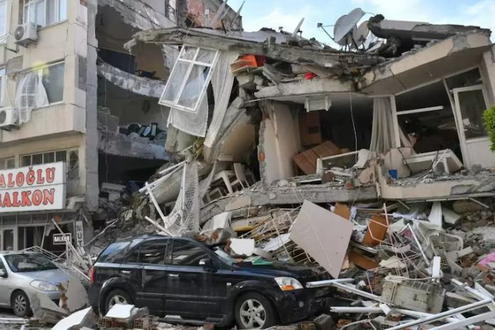 Earthquake Devastation in Shigatse, Tibet A building collapsed due to an earthquake, with rubble scattered and a damaged black car in the foreground.