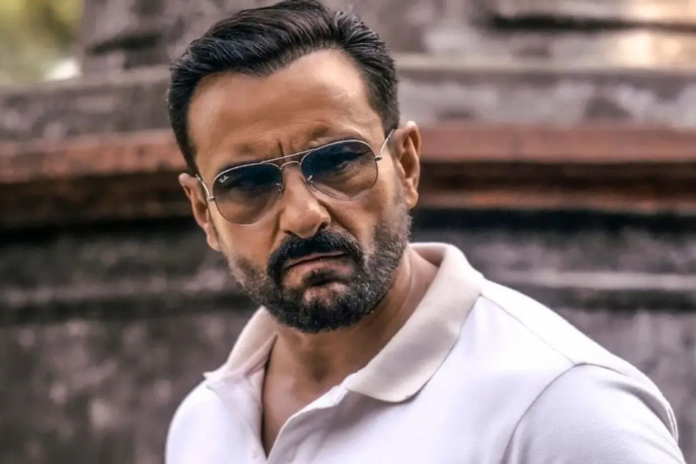 Saif Ali Khan wearing sunglasses and a white polo shirt, looking intense, with a blurred background of a stone structure.